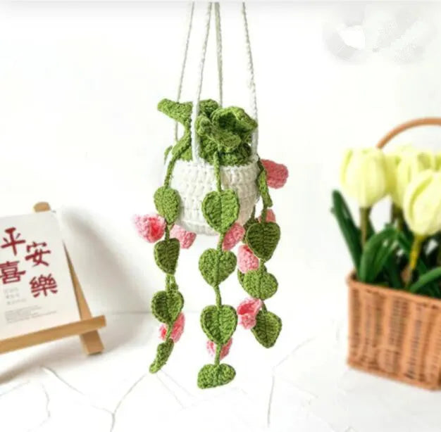 Green and white fish-scale style knitted wool car hanging planter with 8cm base and long white cord.