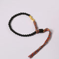 Hand-woven obsidian carrying strap bracelet showing textured weave and 4mm width