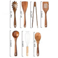 Wooden kitchen utensil set with seven pieces including spoons and spatula arranged together