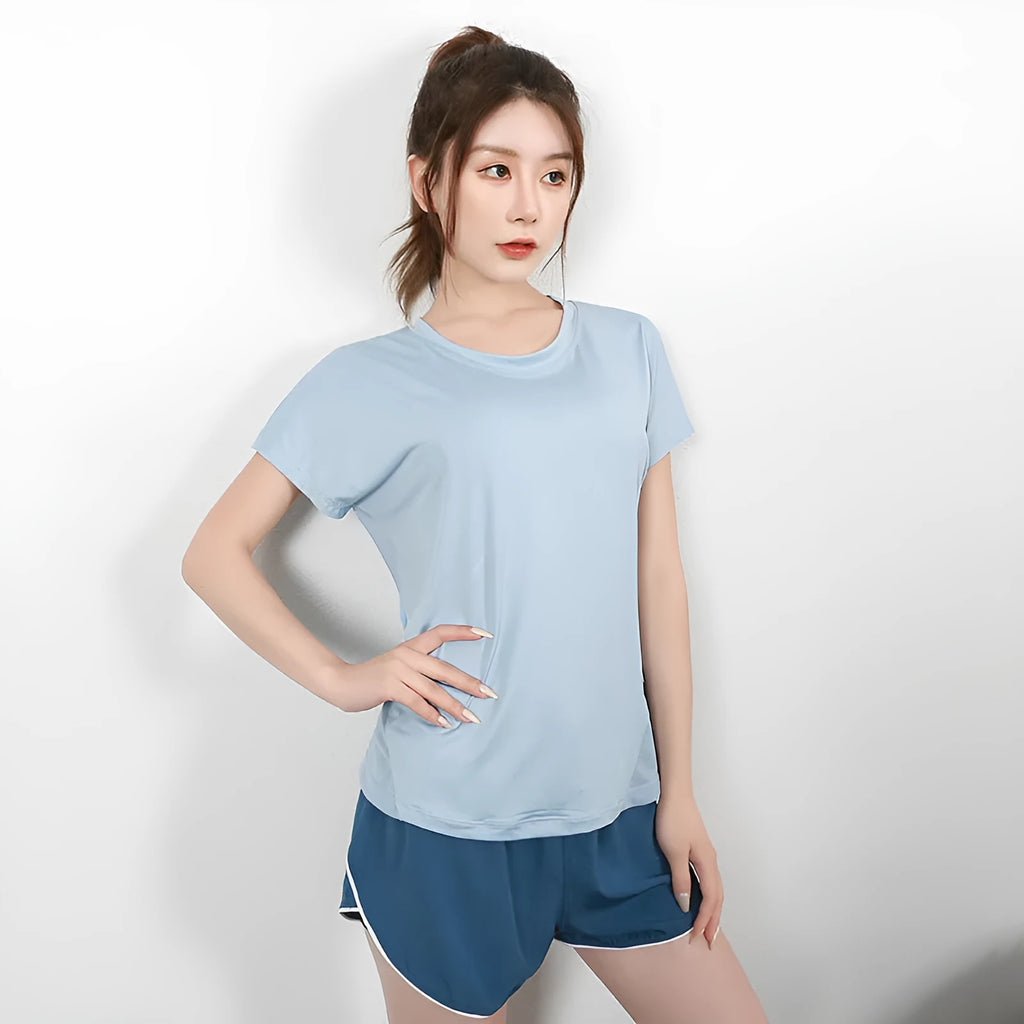 Women's pink polyester short sleeve sports T-shirt for running and fitness.