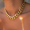 Women's gold chunky chain necklace showing thick links and pendant detail