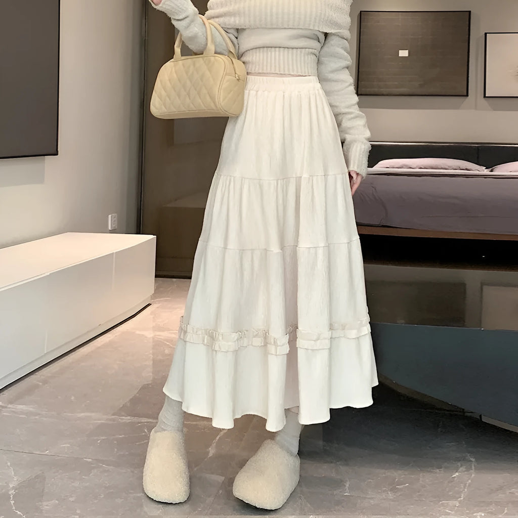 Women's beige corduroy A-line midi skirt with elastic waistband, shown on a hanger.