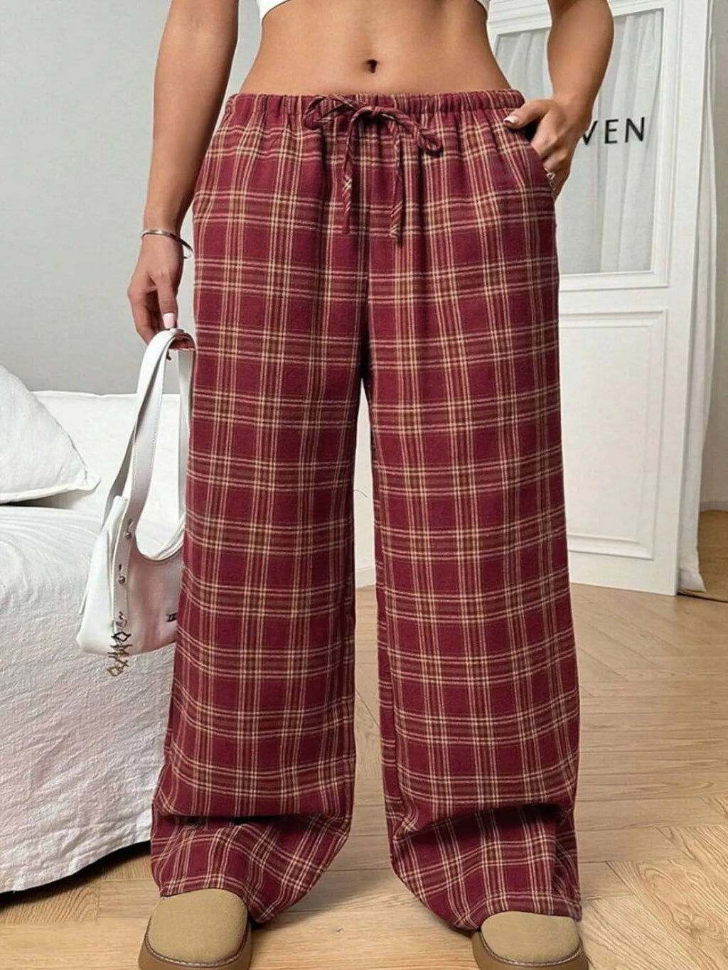 Women's blue and red plaid casual trousers with drawstring waist and side pockets.
