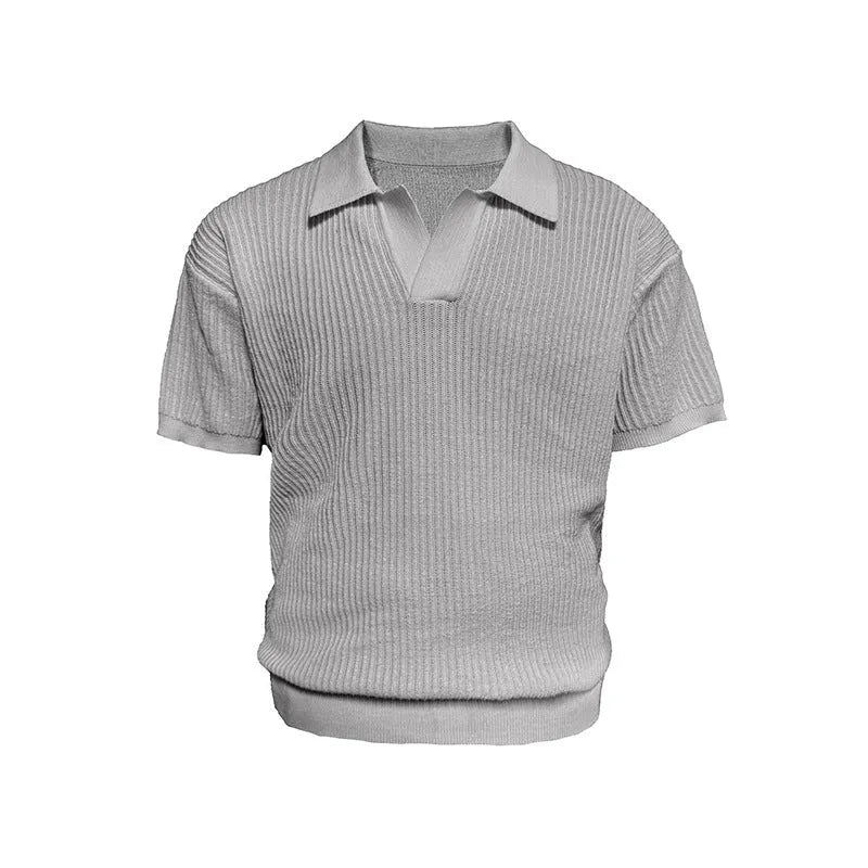 Man wearing a creamy-white loose-fit polo shirt with a striped collar and short sleeves.