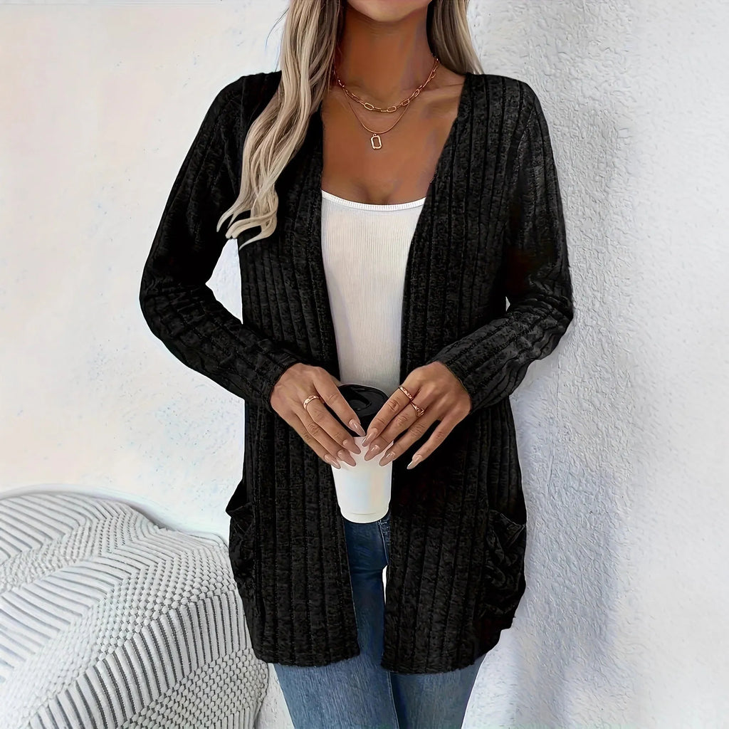 A person wearing a solid grey loose fit long sleeve cardigan with a chest pocket.