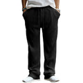 Man wearing loose high-waisted straight-leg casual trousers in army green.