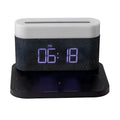 Mini black and white desk lamp with integrated wireless charging pad and clock display.
