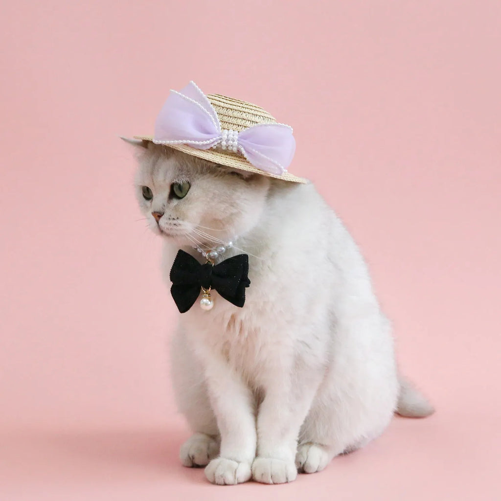 Pink pearl bow woven straw hat for a cat, shown in size S (13cm) on a mannequin head.