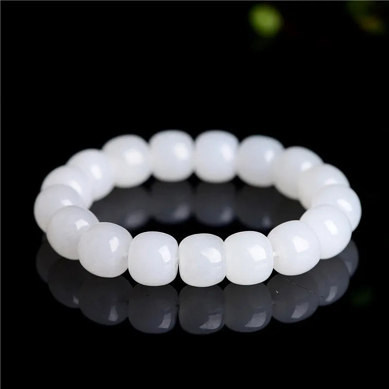 White Hetian jade barrel bead bracelet showing smooth polished beads on wrist