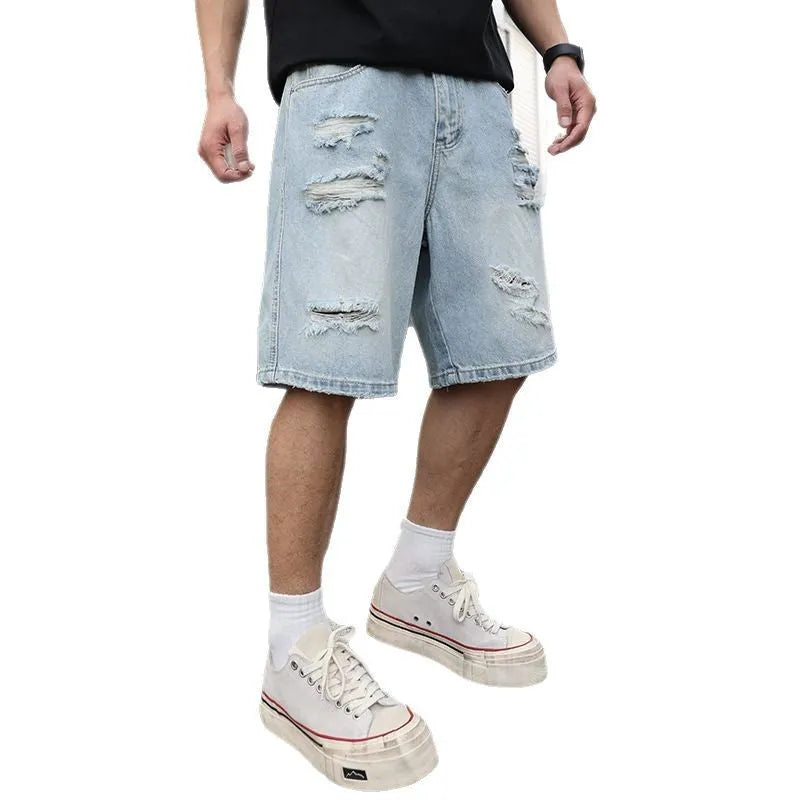 Light blue ripped denim shorts with distressed detailing and straight leg hip hop styling