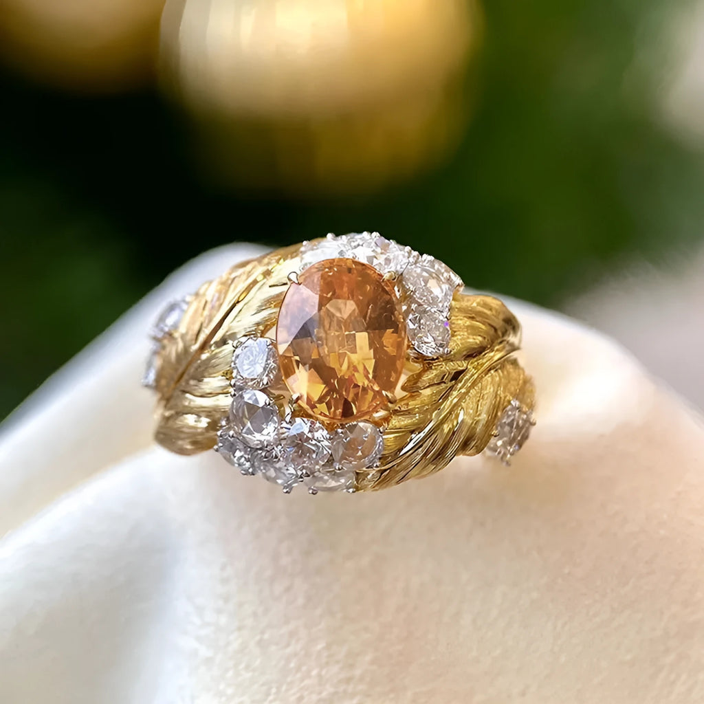 Gold-tone copper women's ring with embossed feather design and inlaid yellow zircon stones.