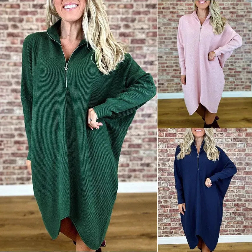 Women's solid colour loose knitted dress with raglan sleeves and a front zip closure.