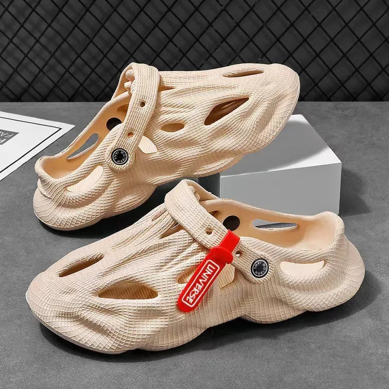 Men's grey EVA foam slippers with closed toe and thickened sole on a sandy beach.