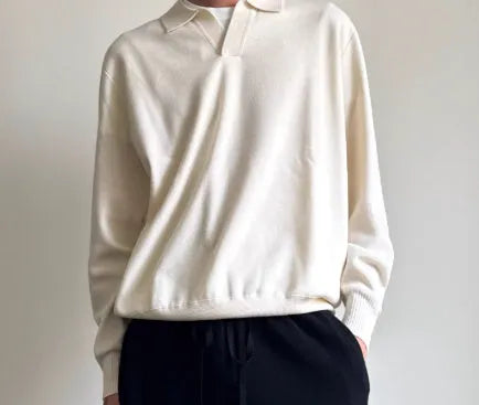Man's milky white pure wool polo sweater with a lapel collar, shown in a loose fit.