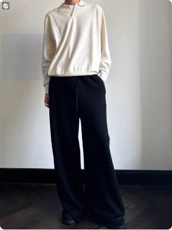 Man's milky white pure wool polo sweater with a lapel collar, shown in a loose fit.