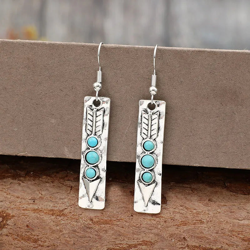 Silver geometric earrings with a long strip design and a blue turquoise inlay