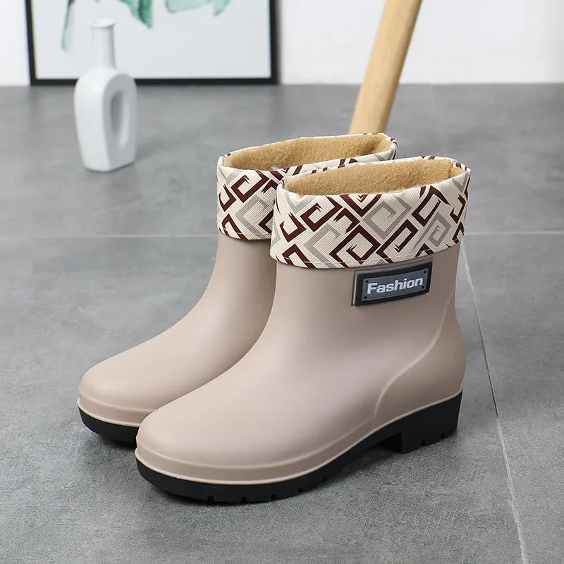Women's mid-calf rain boot in PVC, low heel, shown in black colour.