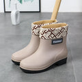 Women's mid-calf rain boot in PVC, low heel, shown in black colour.