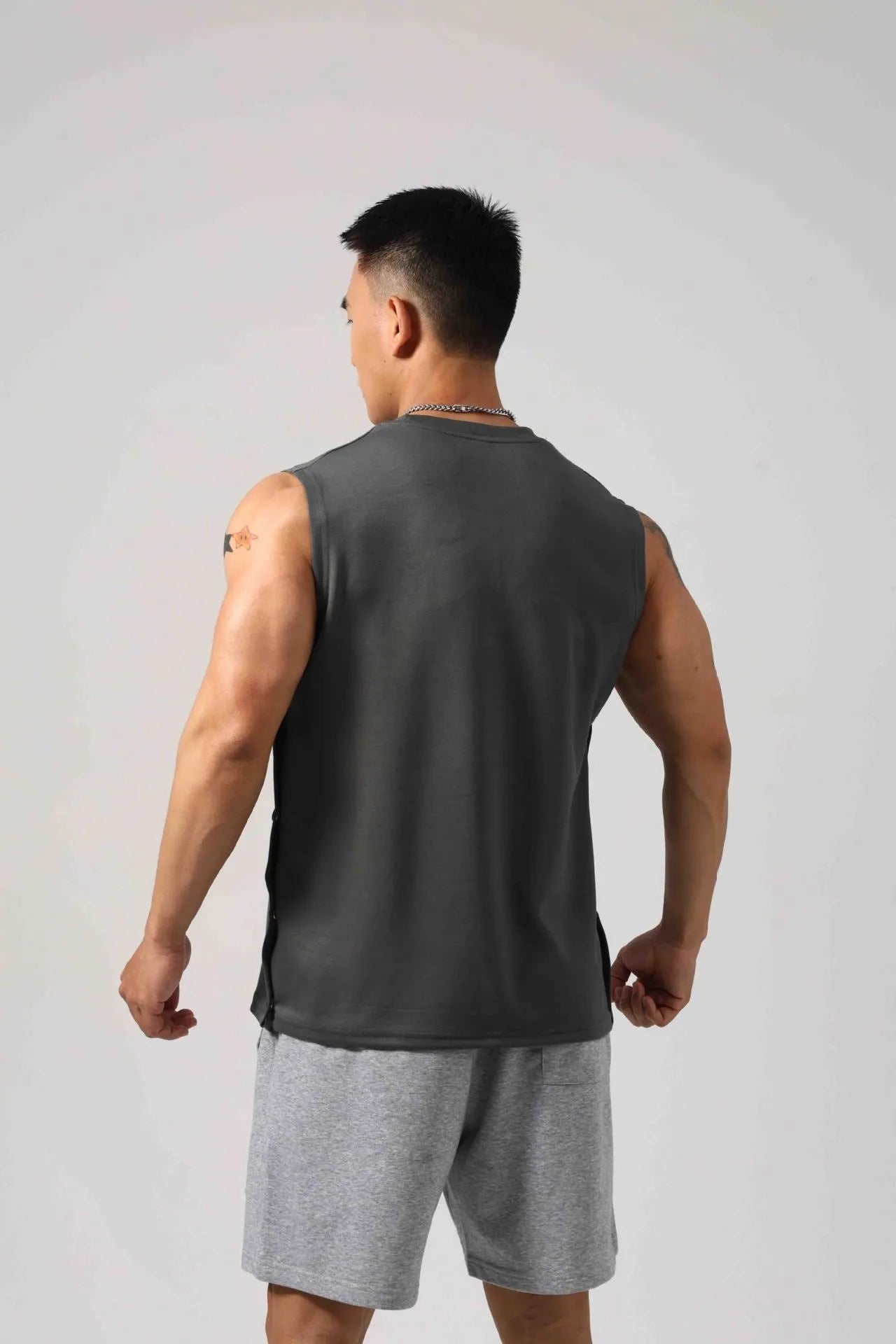 Men's Korean style loose fitness vest with hidden side hooks in solid colour