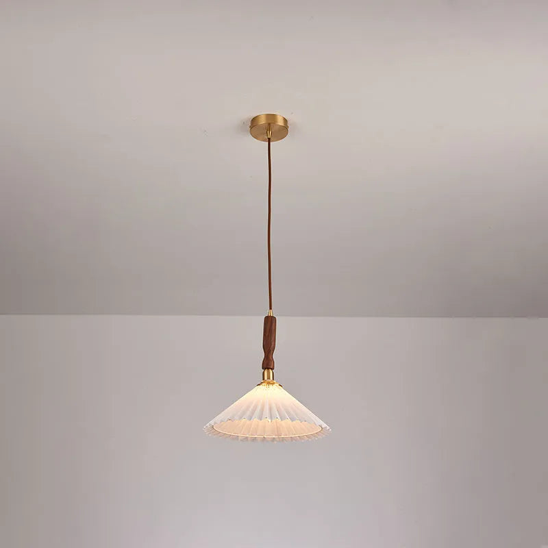American retro style wall lamp with a walnut wood base and white fabric shade mounted on a wall.