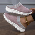 Black women's Flyknit sports slipper with hollowed-out pattern and striped design on a light background.
