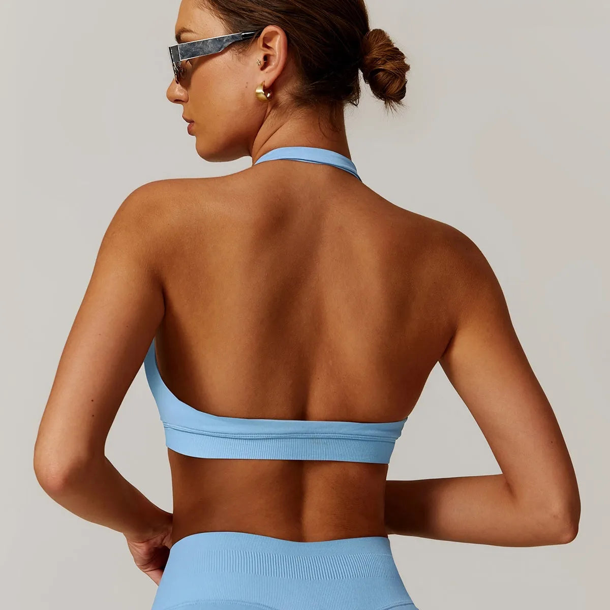 Women's halter neck sports bra in nylon with built-in pads and medium support
