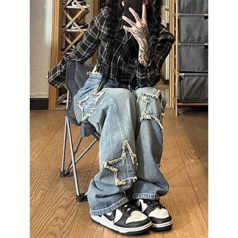 Blue high-waisted wide-leg denim trousers laid flat, showing straight cut and front detail.