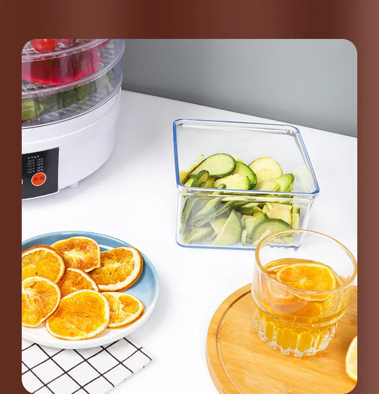 White five-layer food dehydrator with stackable mesh trays on a kitchen countertop.