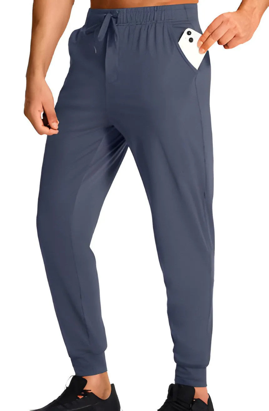 Men's loose fit solid colour casual trousers in polyester fabric on a hanger