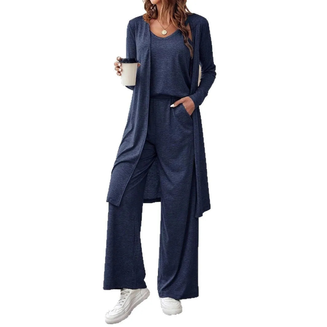 Blue women's three-piece co-ord suit with jumper top, long cardigan, and trousers with suspenders.