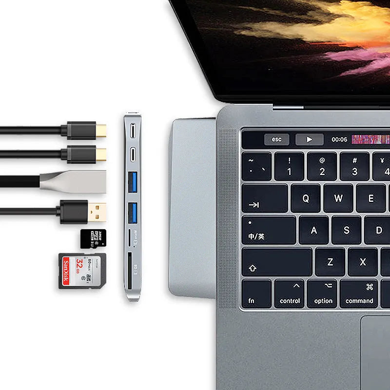 Silver 8-in-1 USB-C hub for MacBook Pro with dual connectors, showing USB, card reader, and charging ports