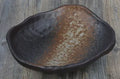 Creative Japanese ceramic sashimi bowl with irregular shape and floral decoration on table