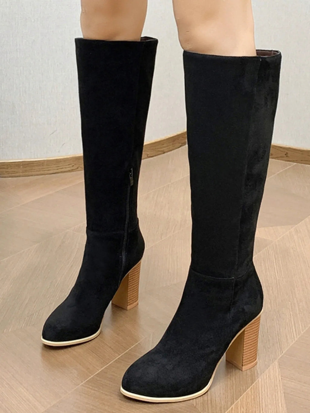 Women's black square toe high heel fashion boots made from artificial PU, shown from the side.