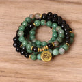 Green and black elastic beaded long bracelet with alloy construction shown on wrist