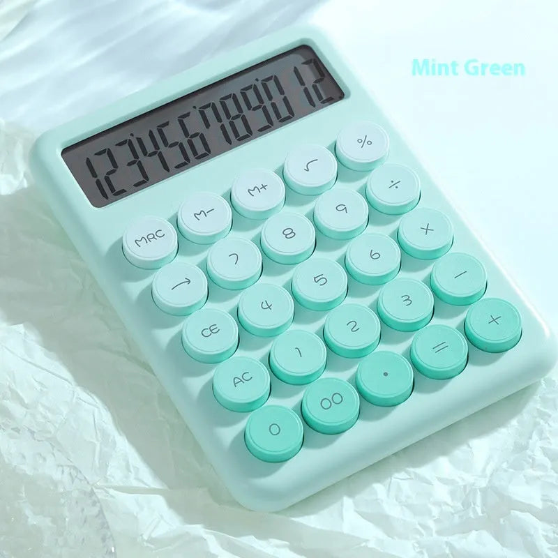 Gradient colour desk calculator in violet, cherry blossom pink, glacier blue, and mint green on a white desk.