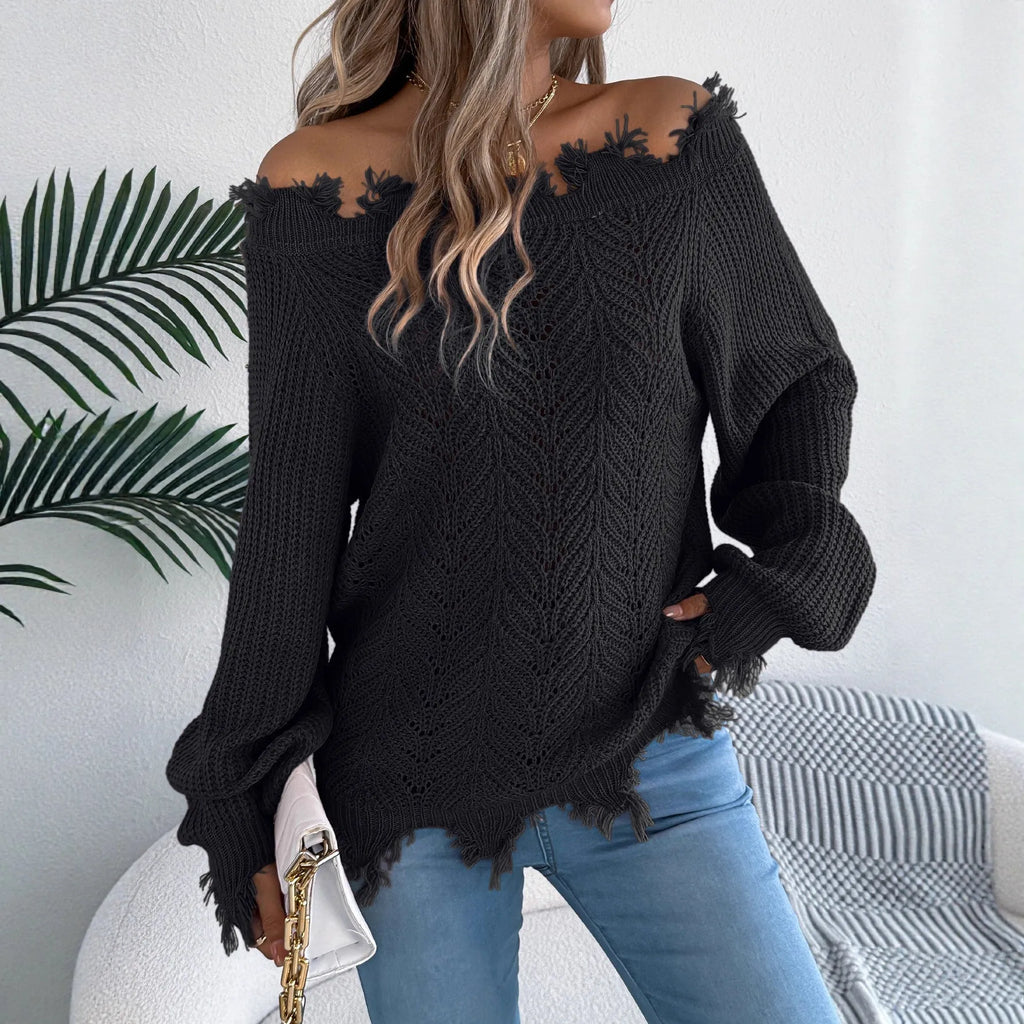 White hollow-out cut off-the-shoulder pullover sweater with long sleeves on a hanger.