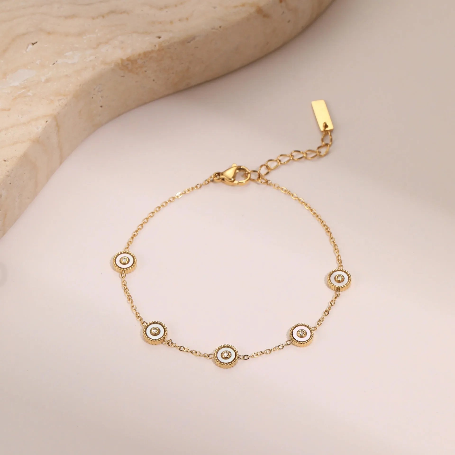 Women's stainless steel bracelet and necklace set with 18K gold plating and geometric design.