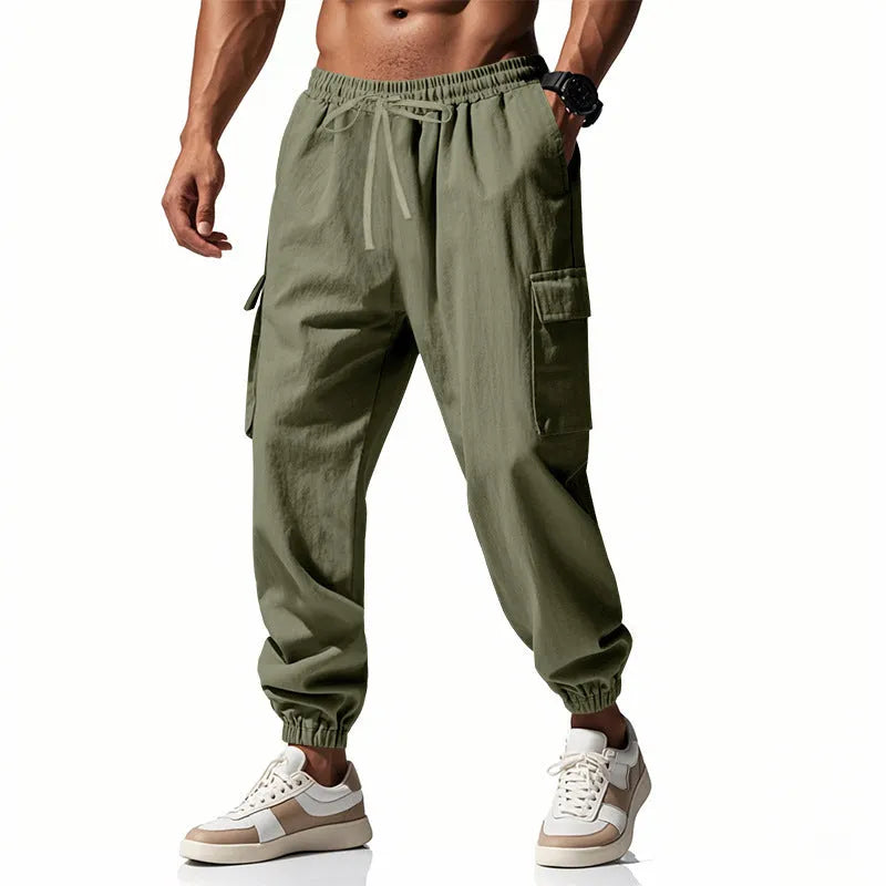 Man wearing khaki linen casual trousers with ankle-tied cuffs and multiple pockets.