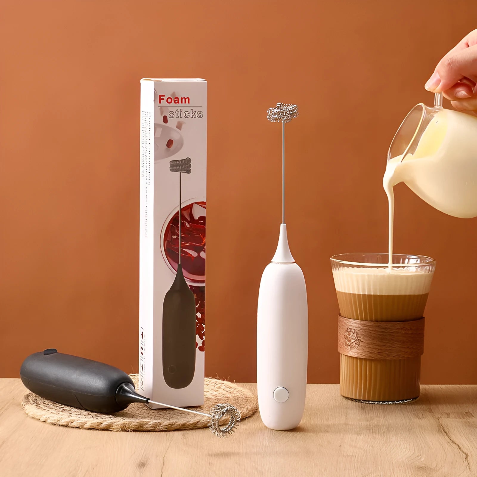 Black and white hand-held electric milk frother blender for coffee