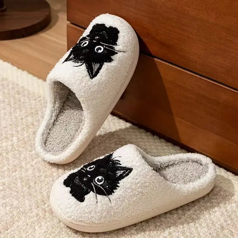 White plush couple slippers with black beard cat cartoon design and non-slip soles.