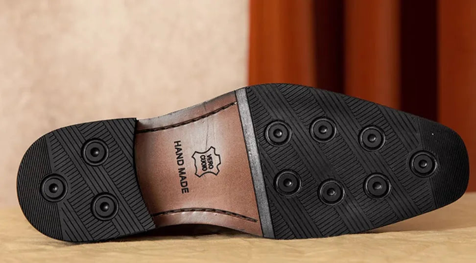 Men's black leather slip-on loafers with fringed detailing and polished finish