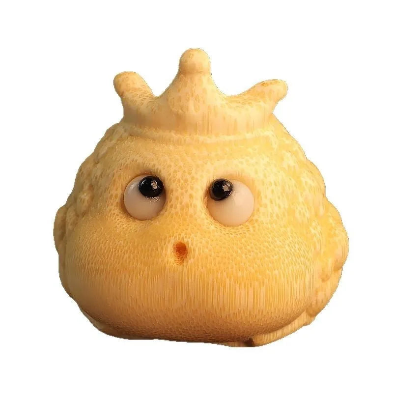 Solid bamboo carving of a cute Crown Princess toad ornament on a wooden surface.