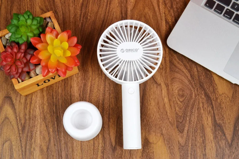 White ORICO FH1 portable USB rechargeable desk fan with fine-line texture on a desktop