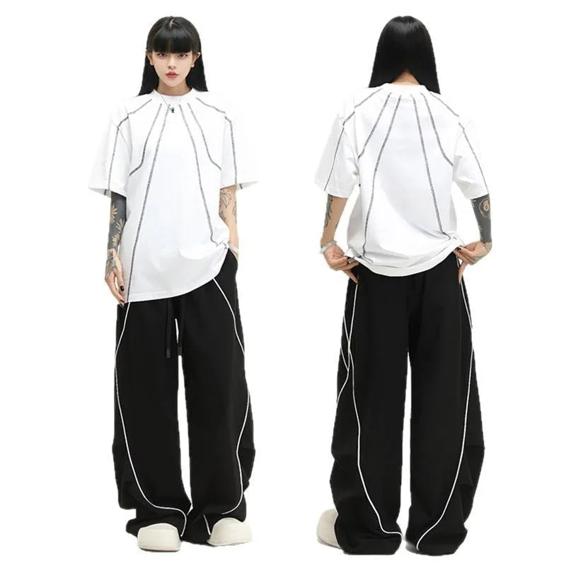 Black striped pleated hip hop sports wide-leg pants on hanger showing loose fit and mid-waist design