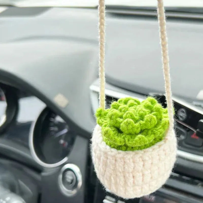 Green and white fish-scale style knitted wool car hanging planter with 8cm base and long white cord.