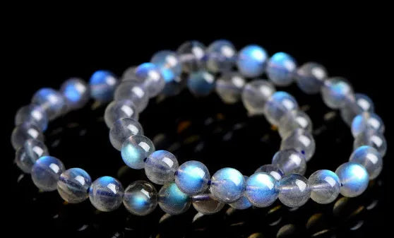 Natural cream coloured crystal bracelet with smooth ground beads, shown in a minimalist unisex style.