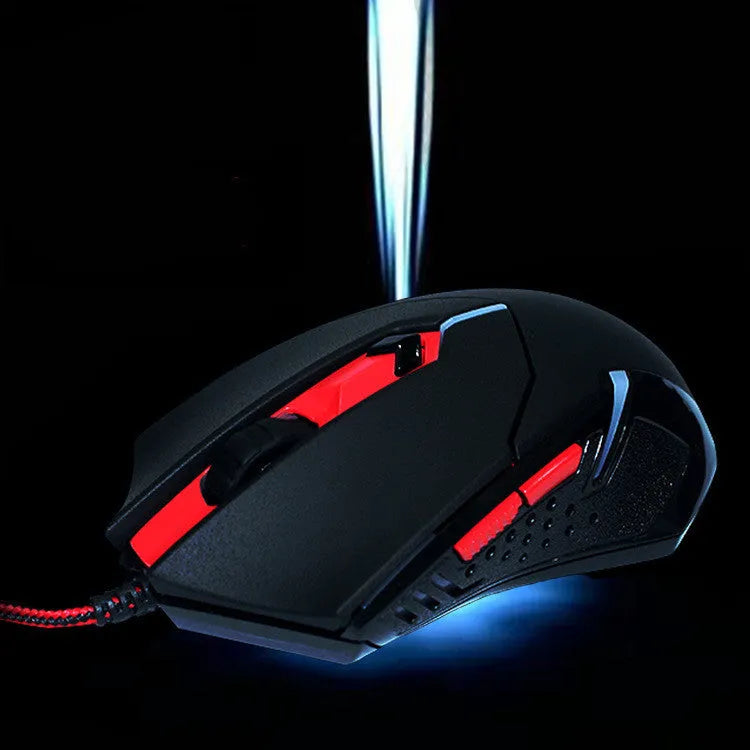 Black and red wired USB optical computer mouse with six buttons on a desk.