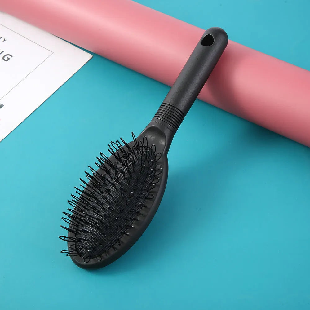 Black ring tooth hair extension comb with airbag cushion measuring 22cm long