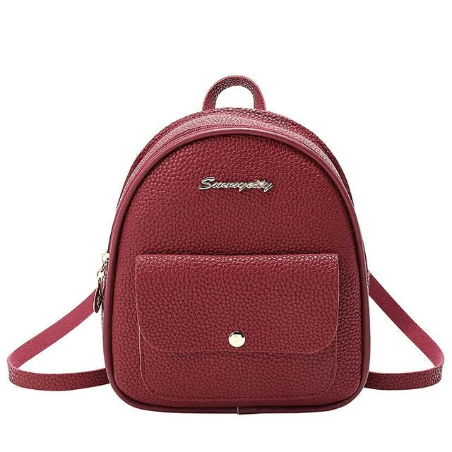 Small black PU women's shoulder backpack with zipper closure showing compact dimensions