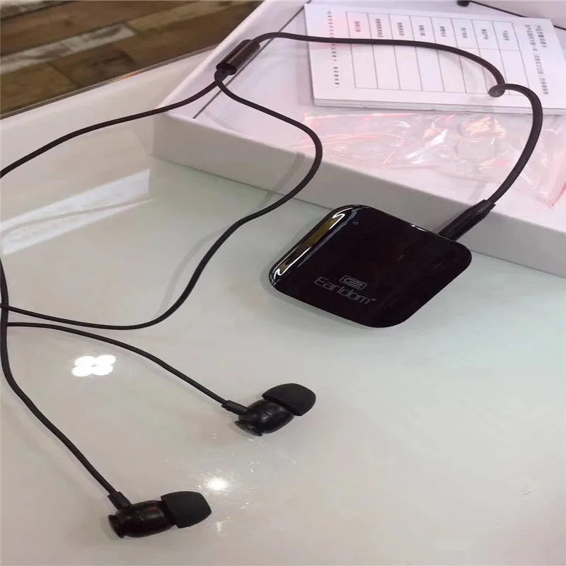 Black Bluetooth lavalier headset with clip, shown alongside packaging.